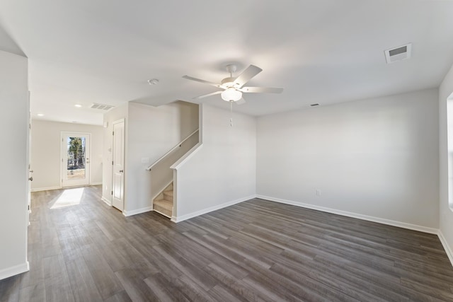 empty room featuring dark wood-type flooring and ceiling fan