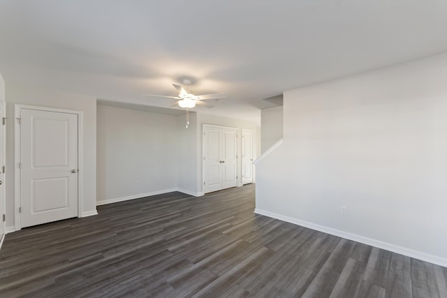 spare room featuring ceiling fan and dark hardwood / wood-style floors