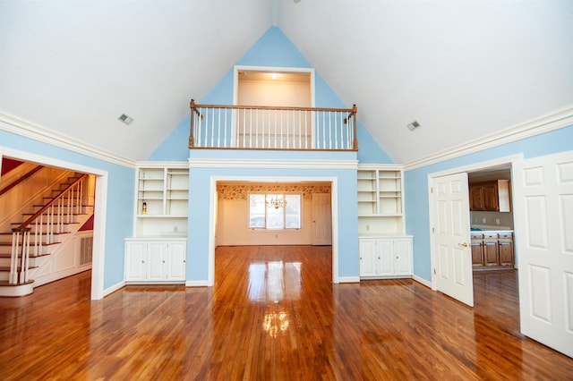 unfurnished living room with vaulted ceiling and hardwood / wood-style floors