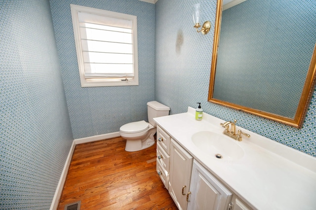 bathroom with vanity, hardwood / wood-style floors, and toilet