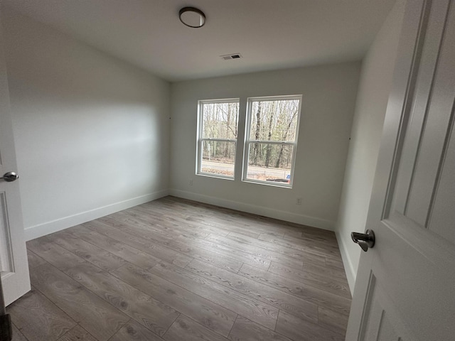 spare room with light wood-type flooring