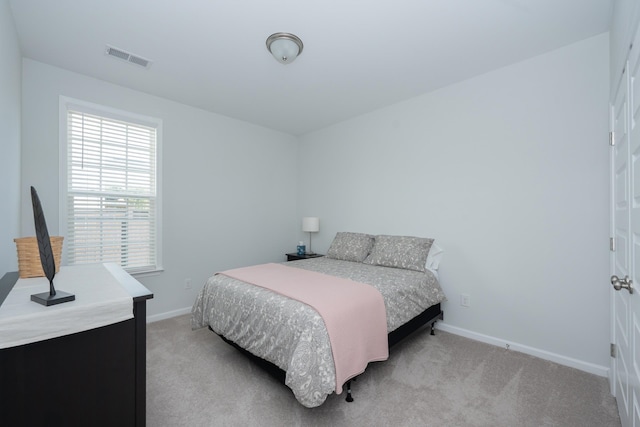 bedroom featuring light colored carpet