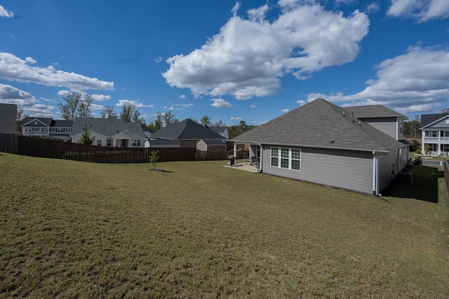 rear view of house with a yard and a patio