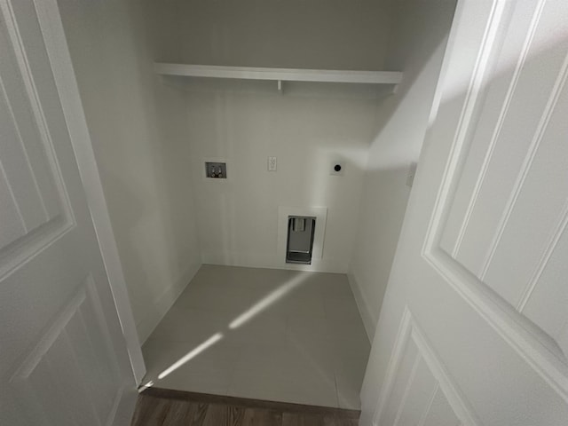 washroom featuring hookup for a washing machine, dark tile patterned flooring, and electric dryer hookup