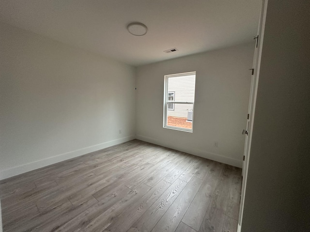 spare room featuring light hardwood / wood-style flooring