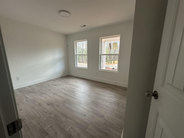 unfurnished room featuring light hardwood / wood-style floors