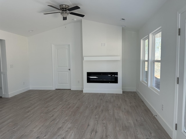 unfurnished living room featuring ceiling fan, vaulted ceiling, and light hardwood / wood-style flooring