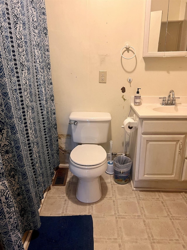 bathroom featuring toilet and vanity