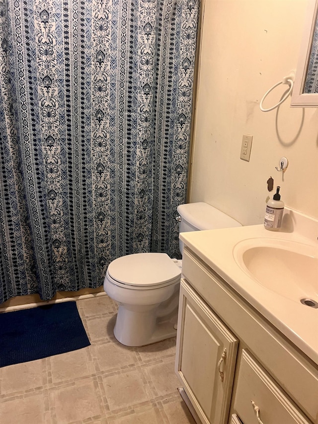 bathroom featuring toilet and vanity