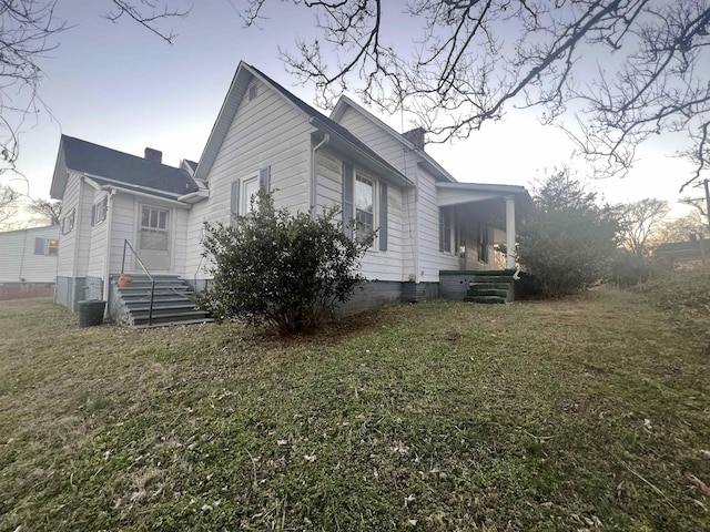 view of home's exterior with a lawn