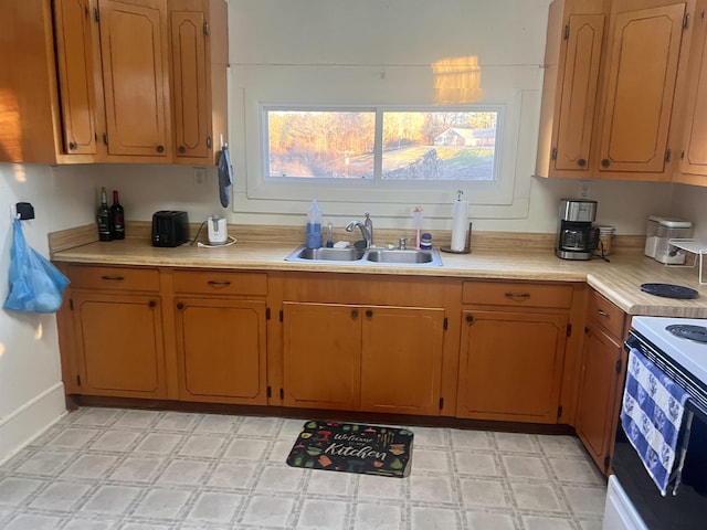 kitchen featuring sink and white electric range