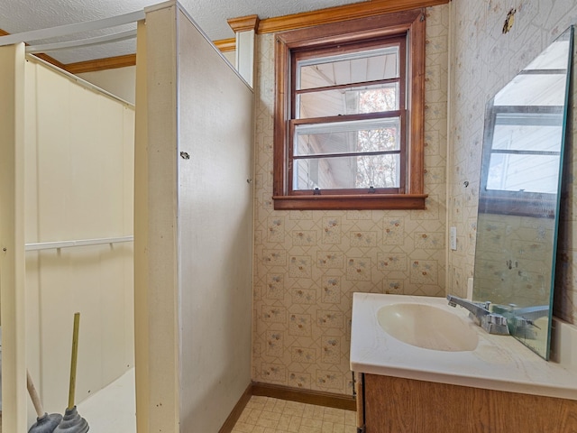 bathroom with a textured ceiling and vanity