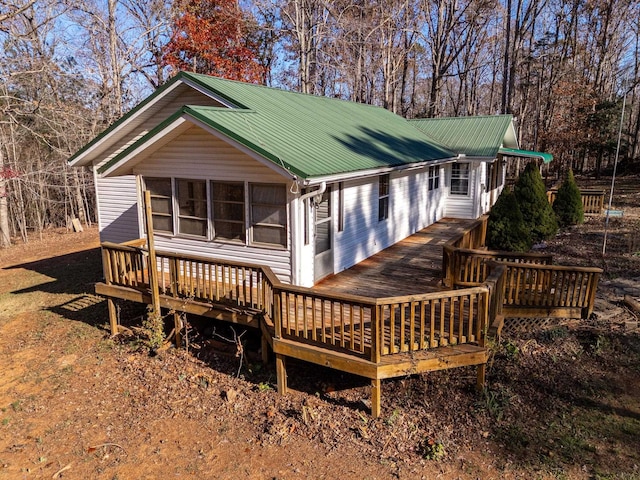 rear view of property with a wooden deck