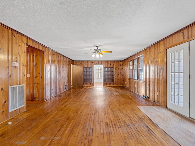 spare room featuring a textured ceiling, ceiling fan, and hardwood / wood-style flooring