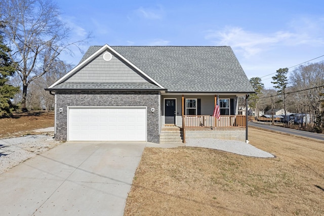 view of front facade with a front yard, covered porch, and a garage