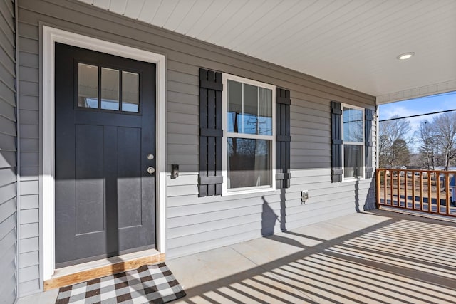 view of exterior entry with a porch