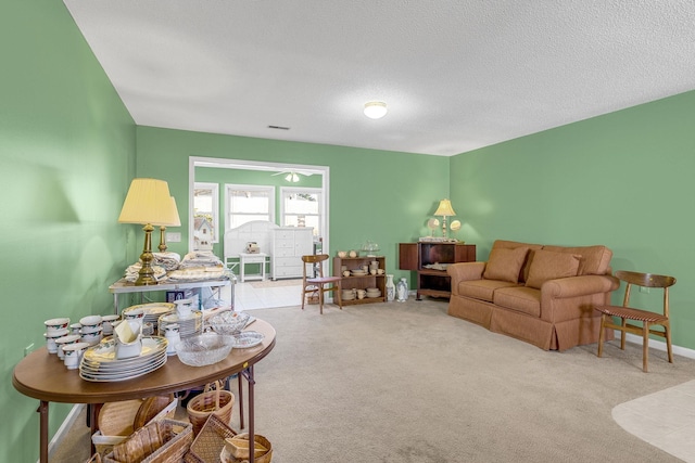 living room with light carpet and a textured ceiling