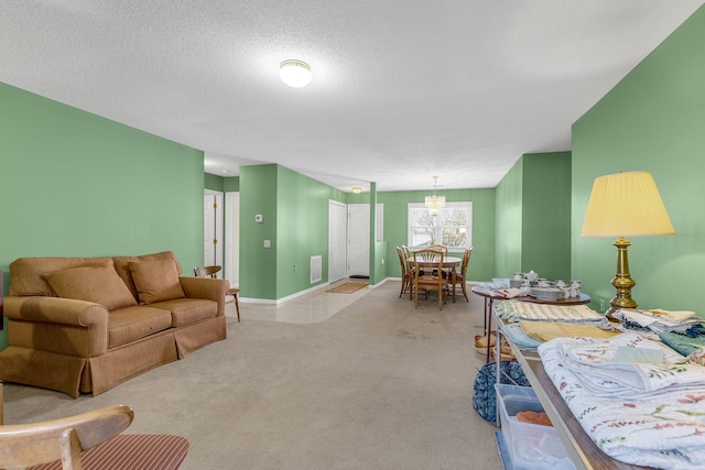 living room with a textured ceiling, a chandelier, and light carpet