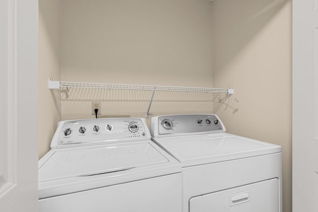 clothes washing area featuring washer and clothes dryer