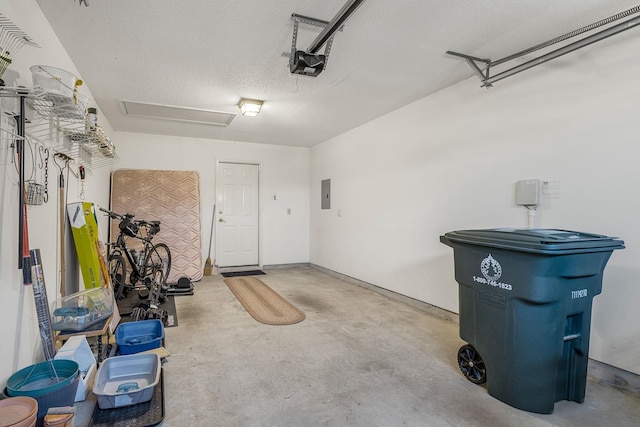 garage with a garage door opener and electric panel