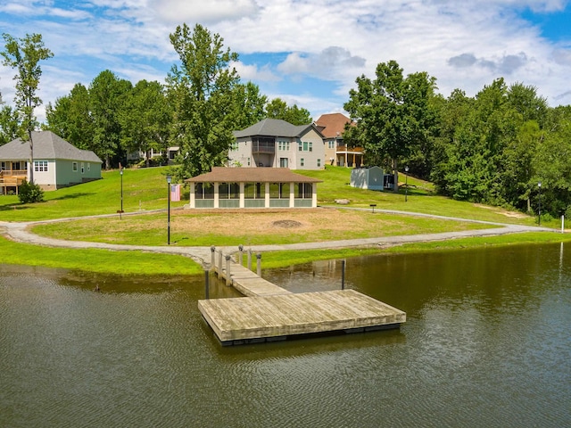 dock area featuring a lawn and a water view