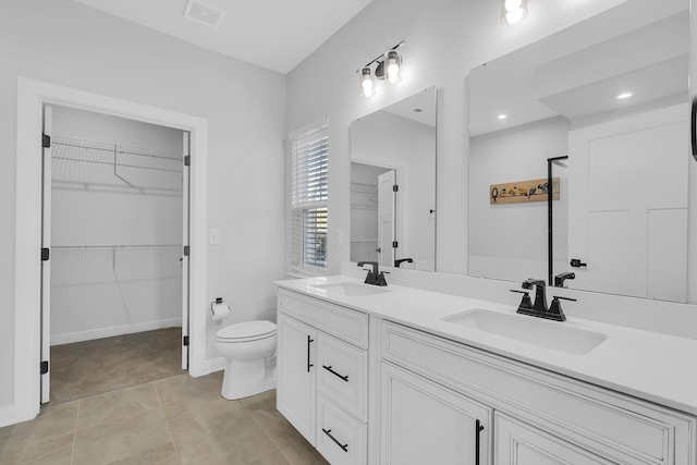 bathroom featuring toilet and vanity