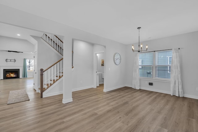 unfurnished dining area featuring light hardwood / wood-style flooring, an inviting chandelier, and a healthy amount of sunlight