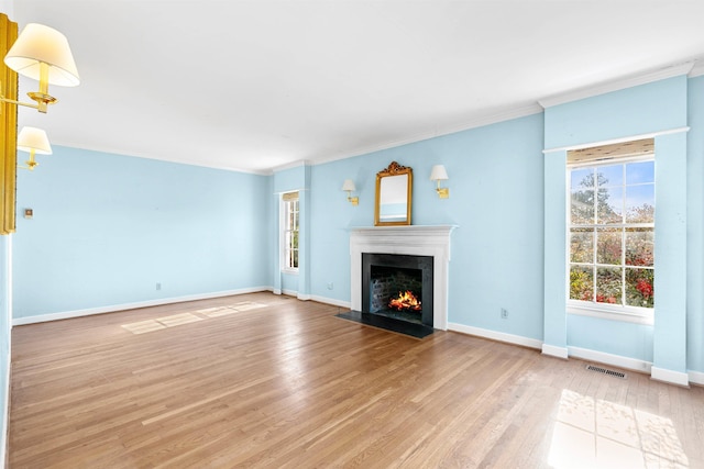 unfurnished living room with ornamental molding and wood-type flooring