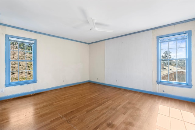 spare room featuring ceiling fan, ornamental molding, and hardwood / wood-style flooring