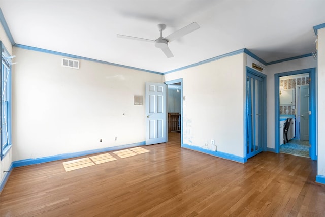 unfurnished bedroom featuring hardwood / wood-style flooring, ornamental molding, and ceiling fan