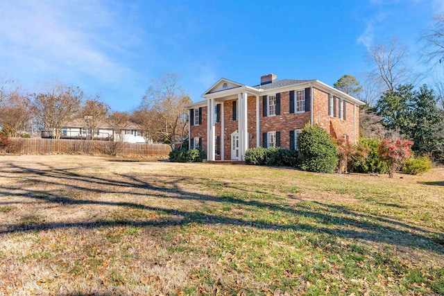 neoclassical home featuring a front yard