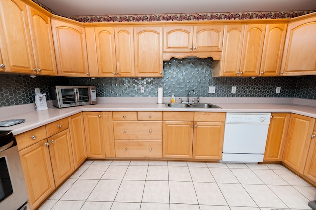 kitchen with light tile patterned floors, backsplash, dishwasher, and sink