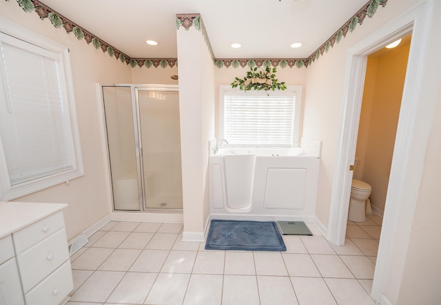 full bathroom with toilet, independent shower and bath, tile patterned floors, and vanity