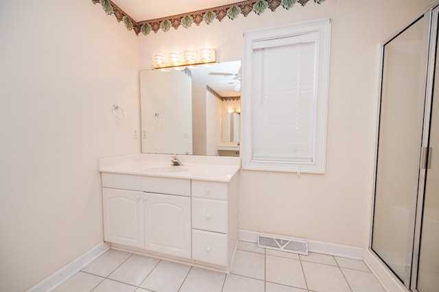 bathroom featuring ceiling fan, tile patterned flooring, walk in shower, and vanity