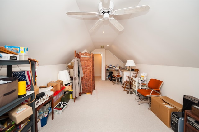 interior space with ceiling fan, lofted ceiling, and carpet flooring