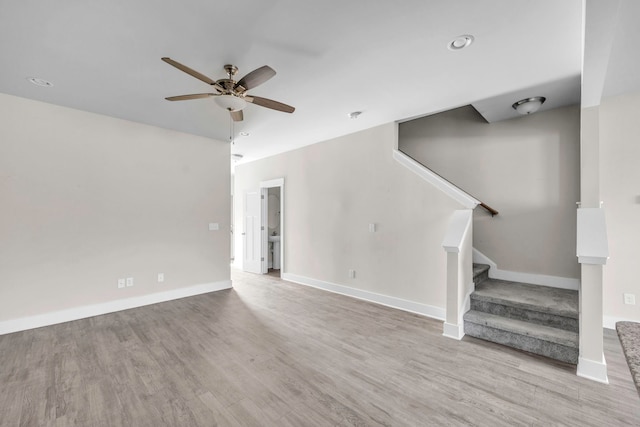 unfurnished living room with light wood-type flooring and ceiling fan