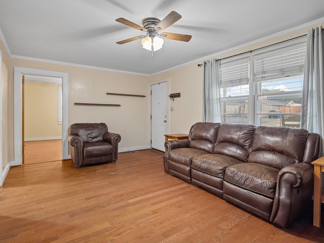 living room with ceiling fan, light wood-type flooring, and ornamental molding