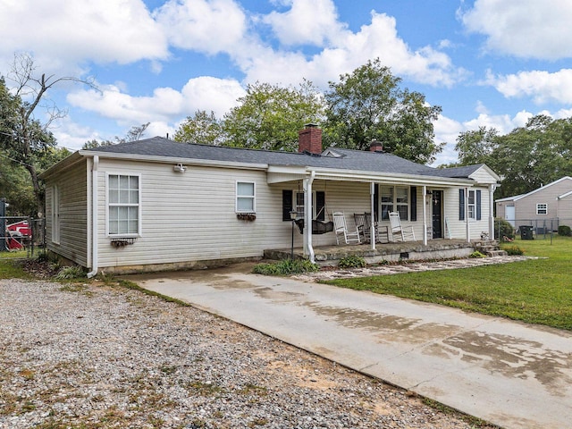 view of front of home with covered porch and a front yard