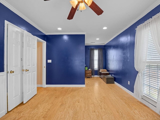 interior space with ceiling fan, light hardwood / wood-style flooring, and crown molding