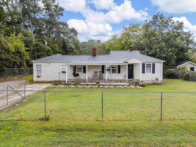 ranch-style home with a front lawn and covered porch