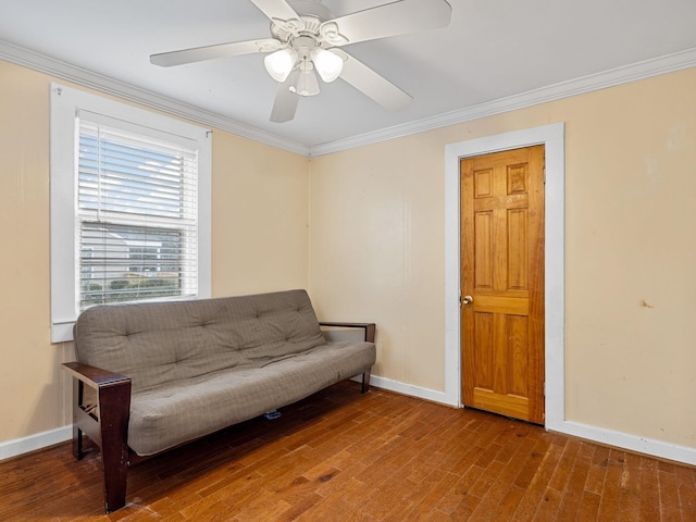 living area featuring ceiling fan, crown molding, and hardwood / wood-style flooring