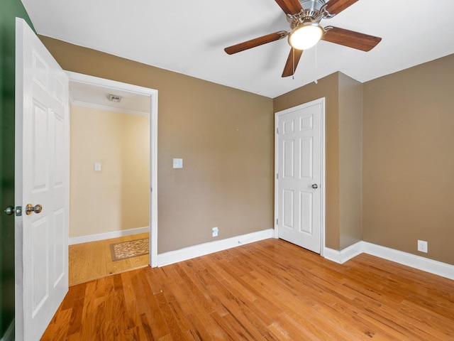 unfurnished bedroom with ceiling fan and light wood-type flooring