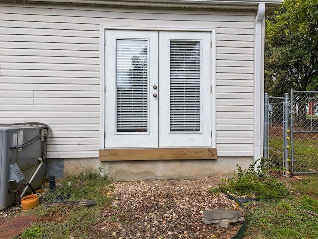 view of exterior entry with central air condition unit and french doors