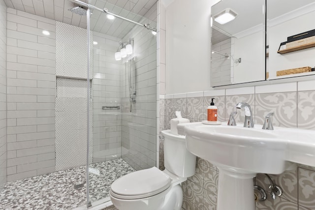 bathroom featuring toilet, backsplash, tile walls, an enclosed shower, and ornamental molding