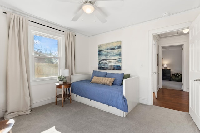 bedroom with ceiling fan, light colored carpet, and ornamental molding