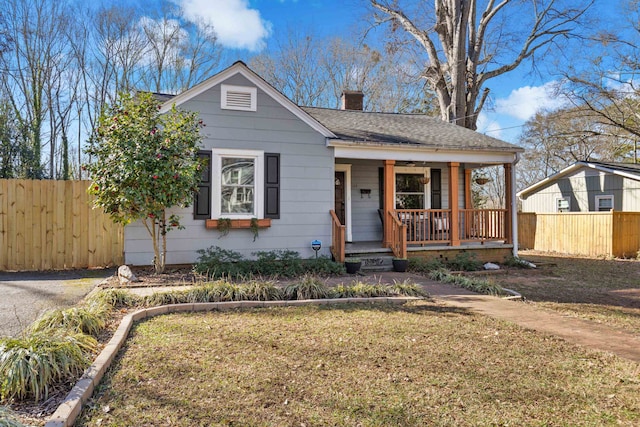 bungalow-style house featuring a front yard and covered porch