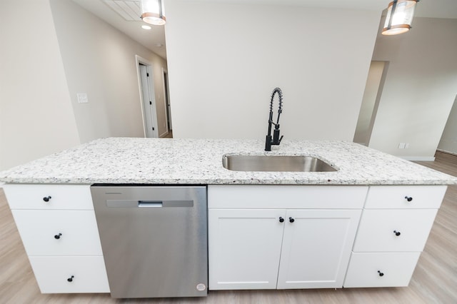 kitchen with white cabinets, dishwasher, an island with sink, sink, and hanging light fixtures