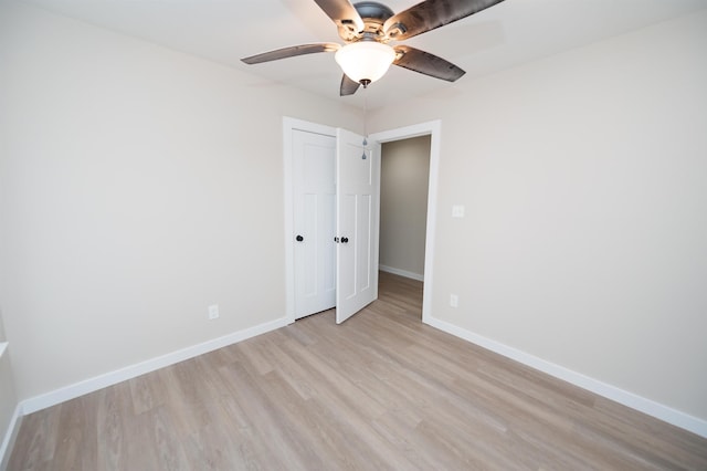 empty room with light wood-type flooring and ceiling fan