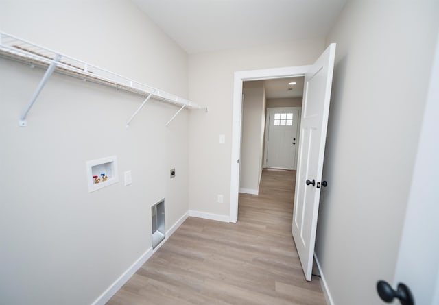 clothes washing area with electric dryer hookup, light hardwood / wood-style flooring, and hookup for a washing machine