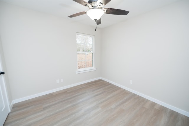 spare room with ceiling fan and light wood-type flooring